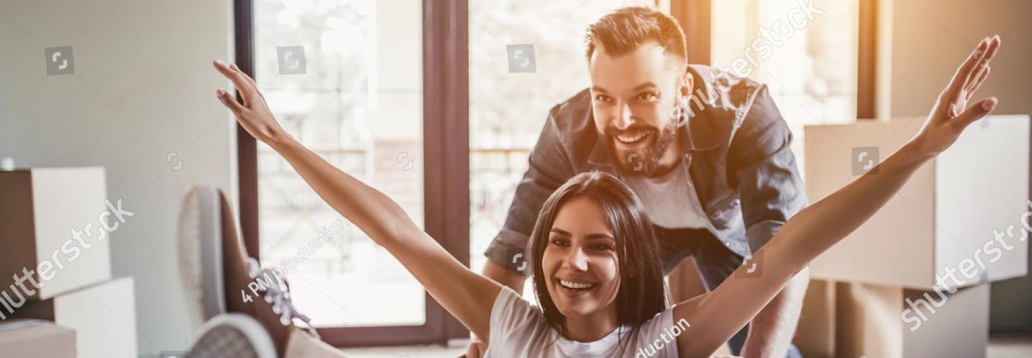 stock-photo-happy-couple-is-having-fun-with-cardboard-boxes-in-new-house-at-moving-day-669633382 